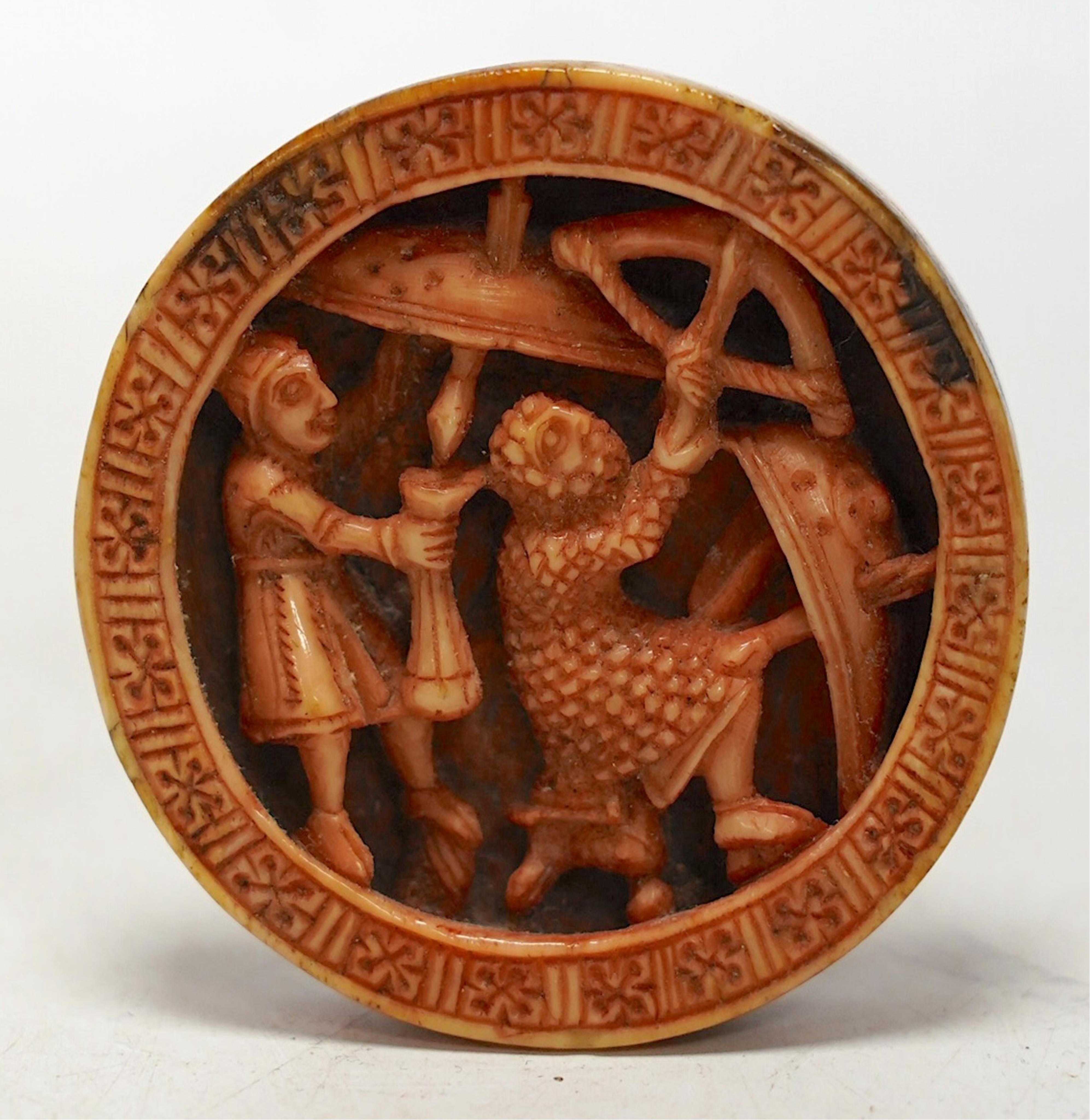 A Romanesque madder stained walrus ivory Tableman or gaming piece, Cologne, c.1140-1180 AD